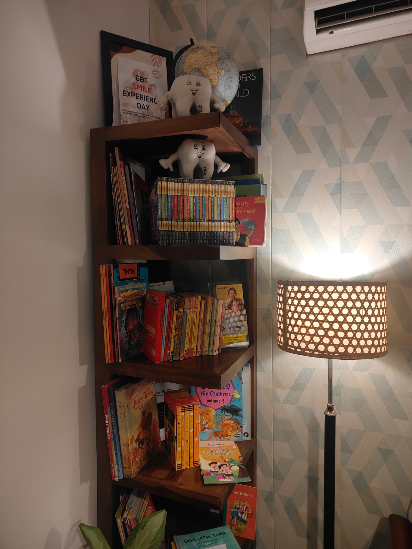 Library bookshelf beside a softly lit reading lamp