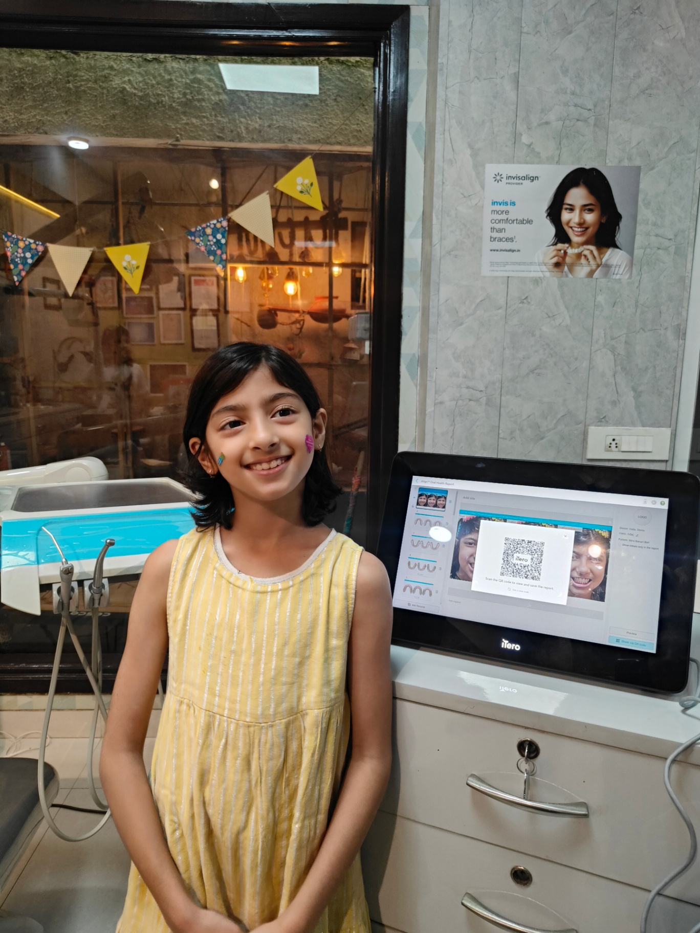 Young patient smiling beside the iTero scanner at Dental Brasstacks