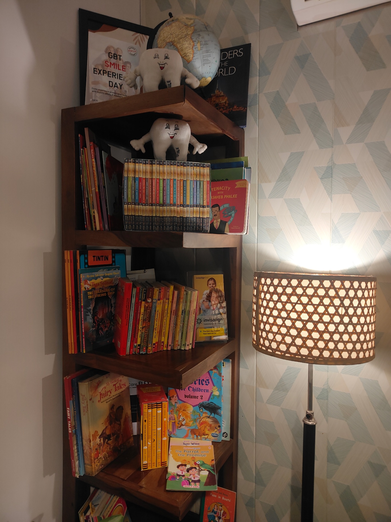Warm light beside the children’s bookshelf at Dental Brasstacks