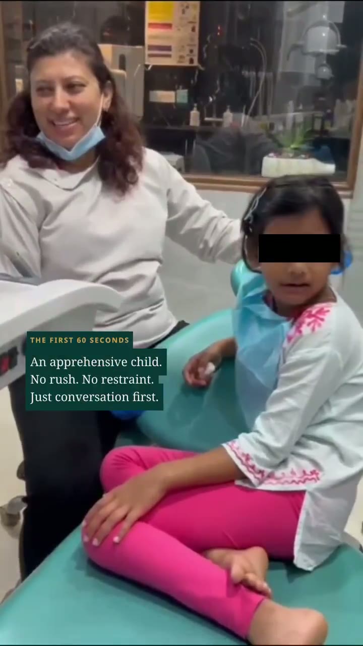 Dr. Nisha Bali settling a child in the dental chair at Dental Brasstacks Gurgaon