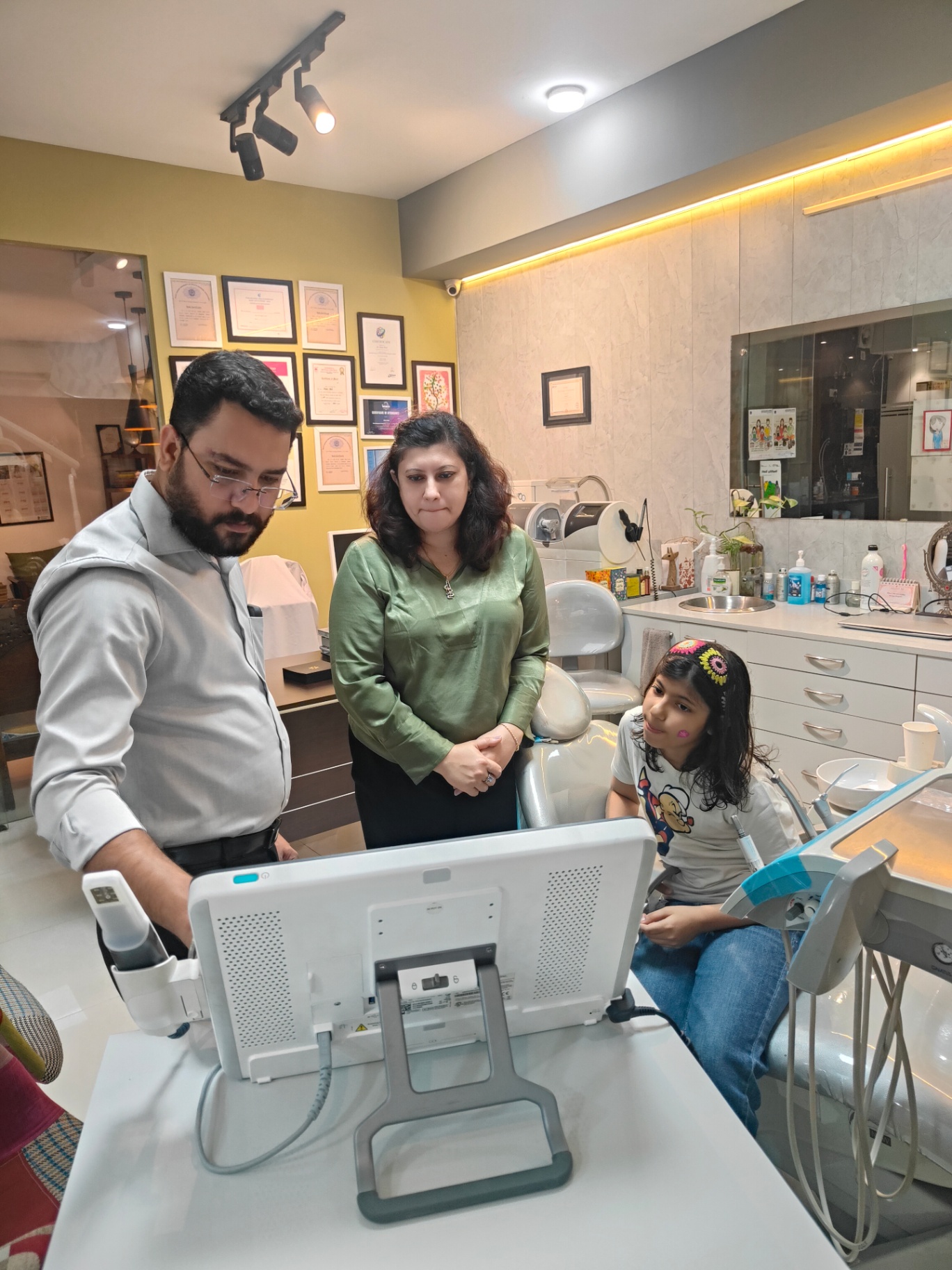 Clinical team reviewing a digital scan with a young patient