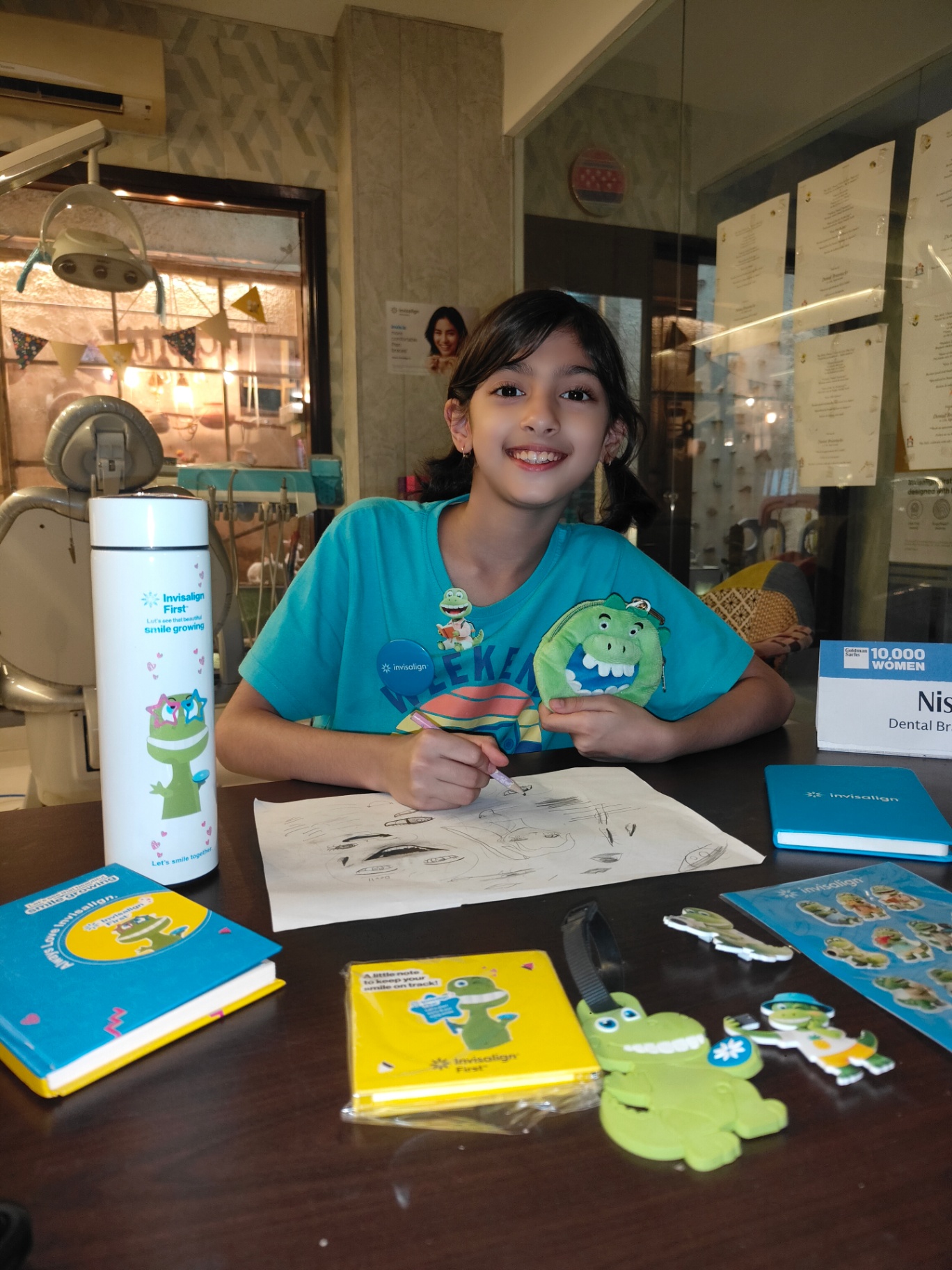 Young Invisalign First patient at the clinic desk