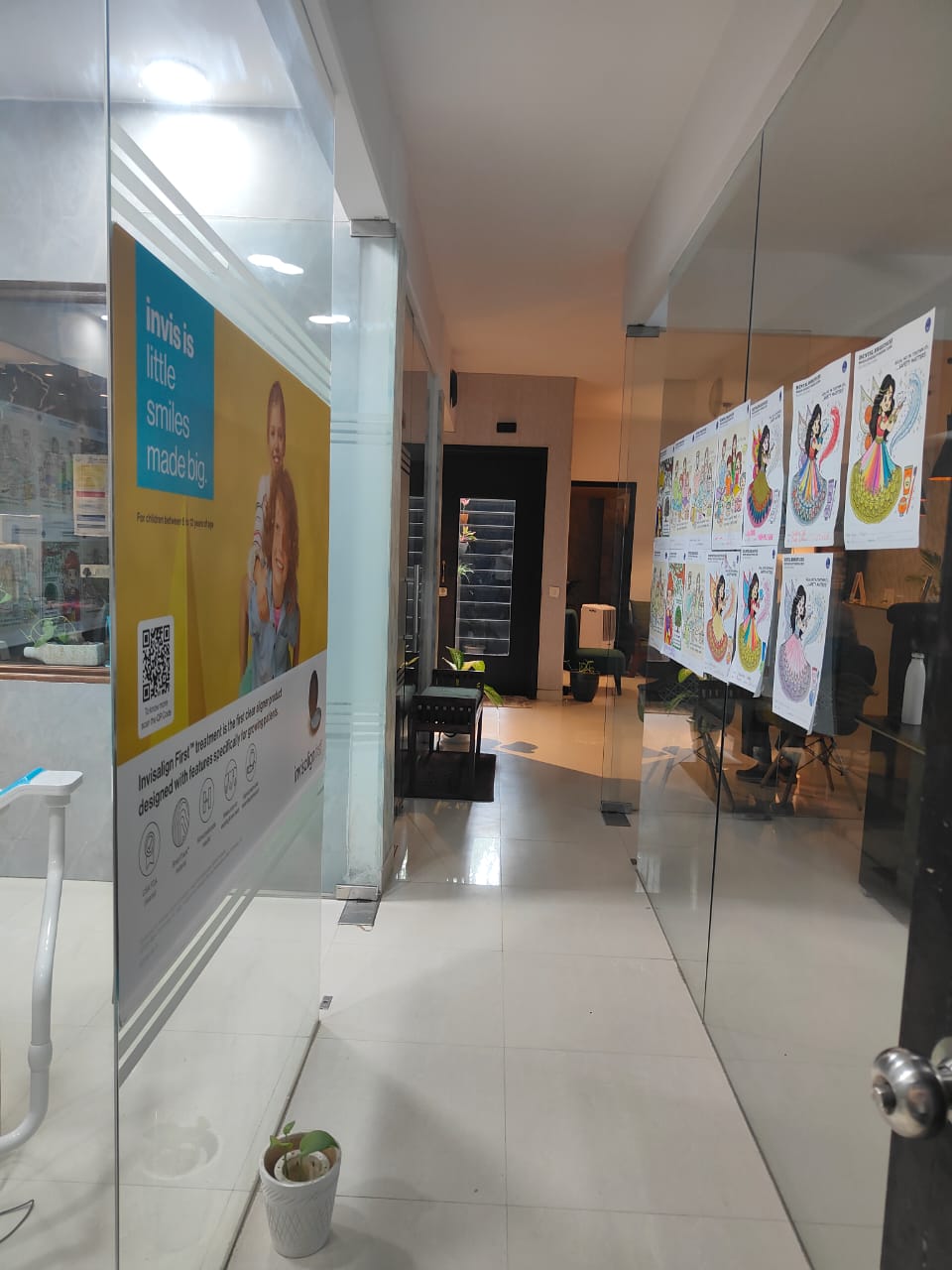 Corridor at Dental Brasstacks with Invisalign First poster and children's coloured artwork lining the walls