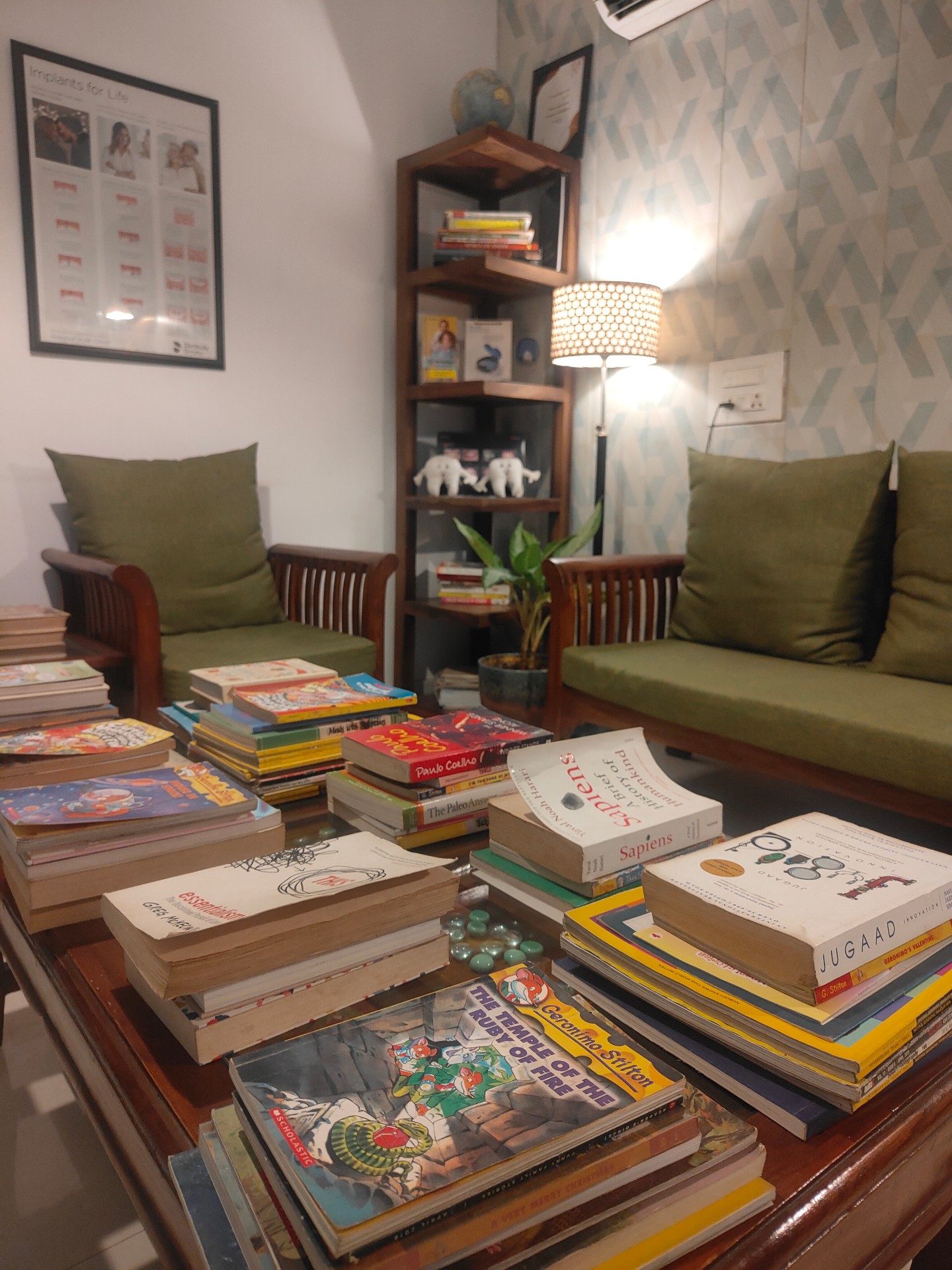 Reading corner at Dental Brasstacks with sofas and stacks of books for waiting patients