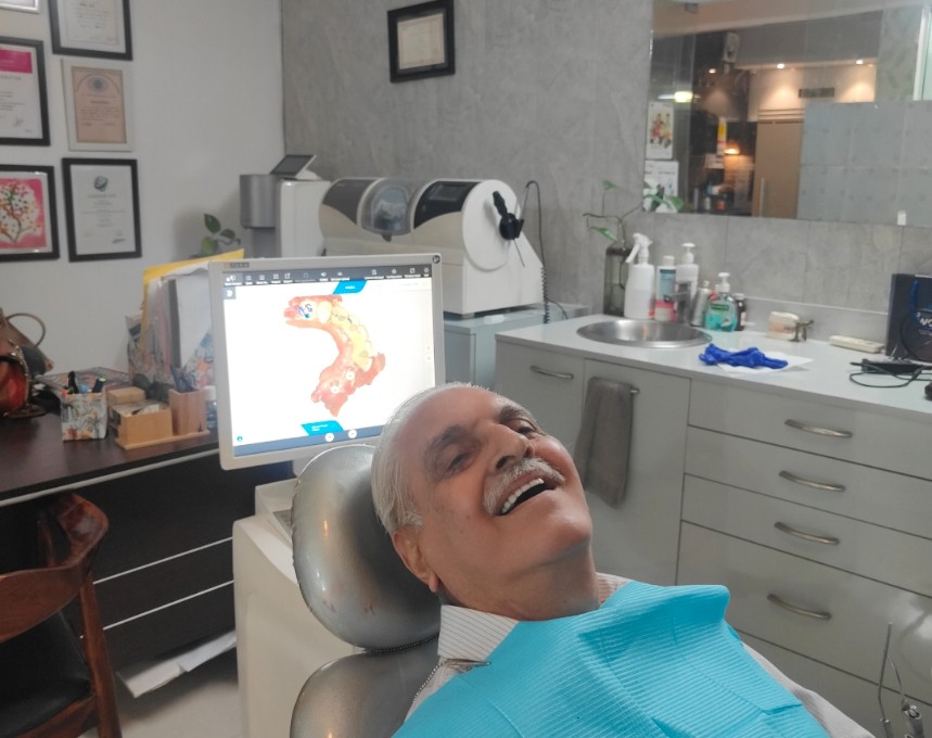 Two smiling Dental Brasstacks patients posing together inside the clinic.
