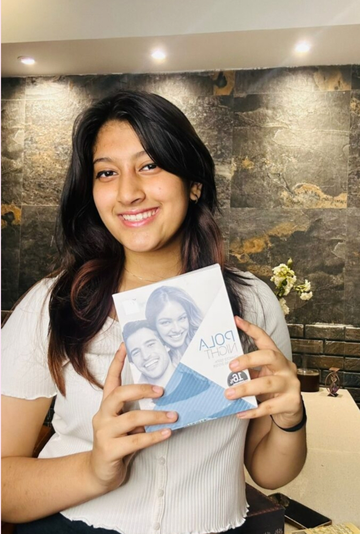 A happy patient at Dental Brasstacks Gurgaon holding a Pola teeth-whitening kit