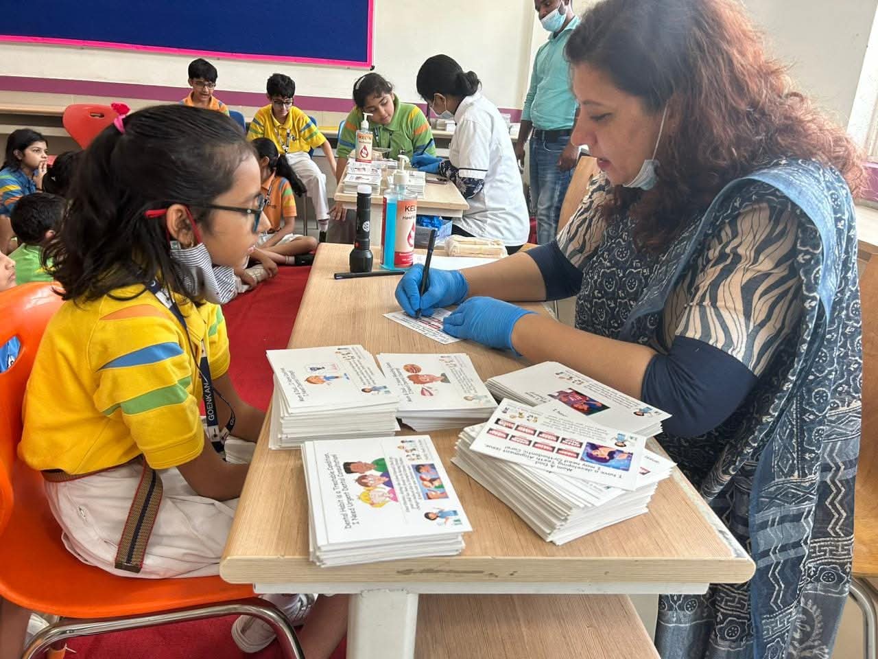 Dental screening at a school using illustrated education cards to explain findings to a student