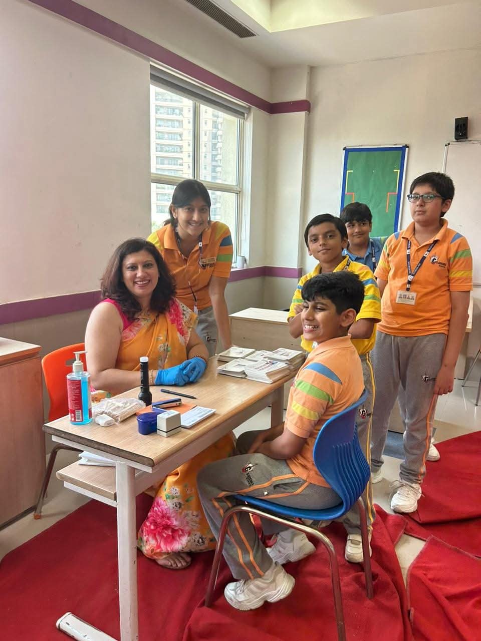 Dr. Nisha Bali screening a group of school students at a dental check-up camp in Gurgaon
