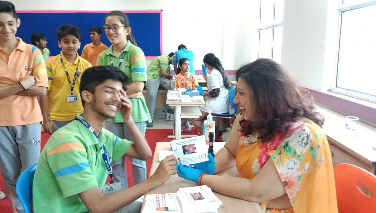 A teenage student smiling during a dental screening at a school health camp