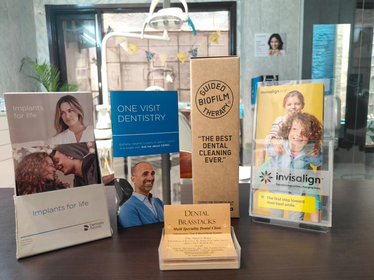 Implants for life, CEREC one-visit dentistry, Guided Biofilm Therapy and Invisalign brochures on display at Dental Brasstacks Gurgaon
